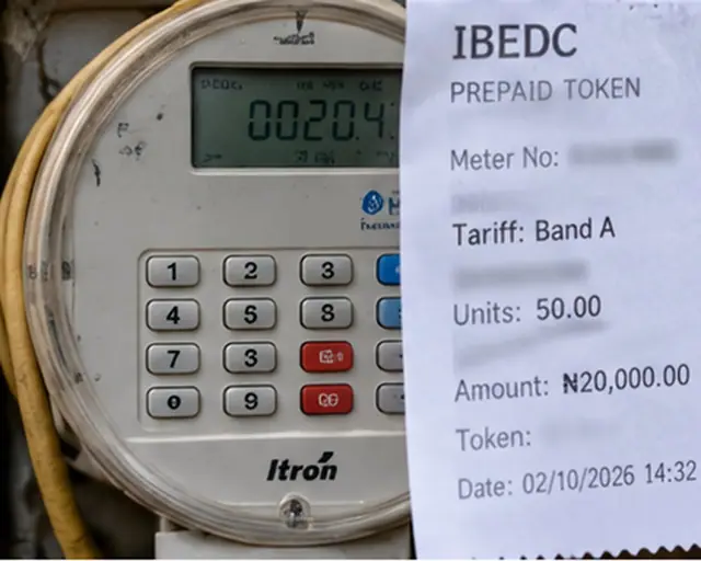 A prepaid electricity meter beside a vending receipt marked Band A.